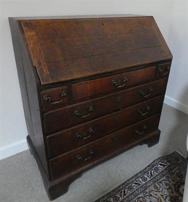 Lot 461 - An Early 18th Century Oak and Pine-Lined Bureau, the fall front enclosing a simple interior of...