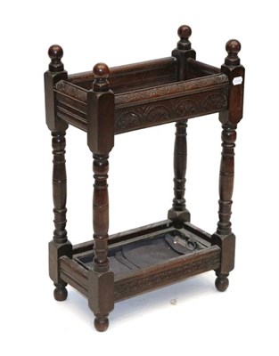 Lot 464 - A Joined Oak Stick Stand, with turned finials above moulded supports and lunette carving above...