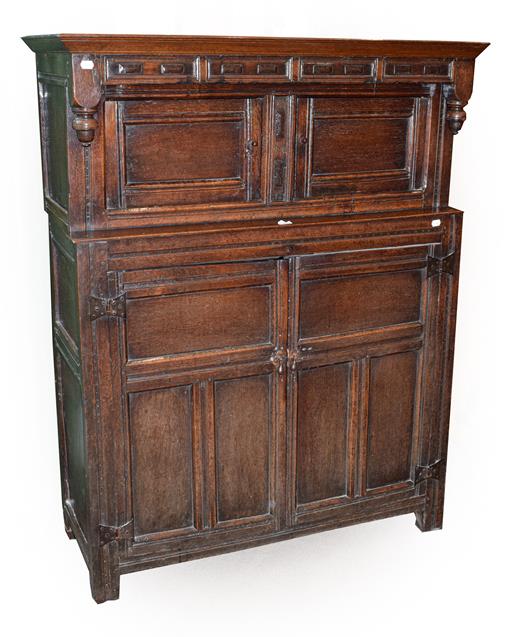 Lot 470 - An Early 18th Century Oak Press Cupboard, the moulded cornice above a geometric carved frieze...