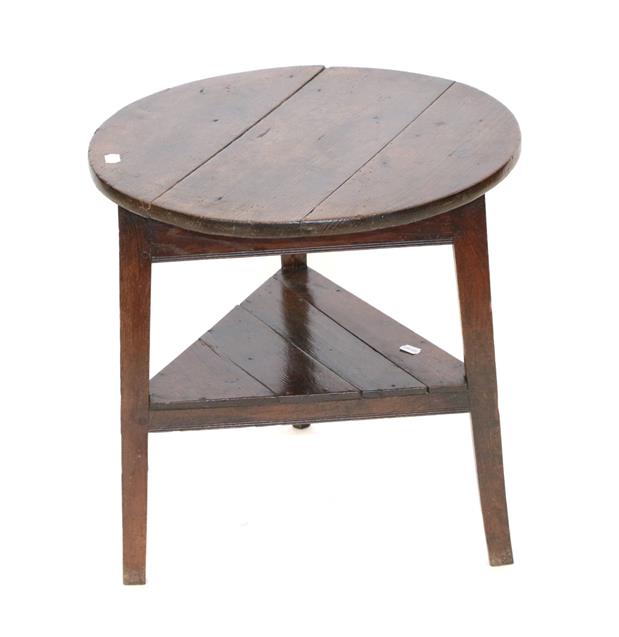 Lot 475 - A George III Oak Circular Cricket Table, early 19th century, the three-plank top above a triangular