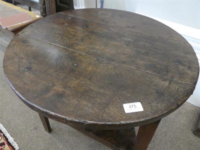 Lot 475 - A George III Oak Circular Cricket Table, early 19th century, the three-plank top above a triangular