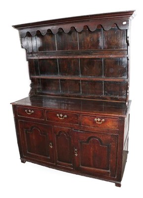 Lot 477 - A George III Oak Dresser and Rack, 2nd half 18th century, the bold cornice above a wavy shaped...