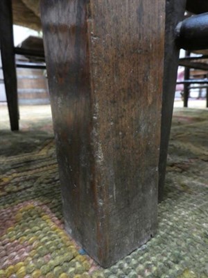 Lot 478 - An Early 18th Century English Joined Oak Dining Table, the two-plank top above a single frieze...