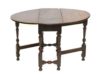 Lot 479 - A Joined Oak Gateleg Dining Table, circa 1700, with two oval dropleaves, on pivoting gatelegs...
