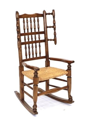 Lot 480 - A Late 19th Century Ash Spindle-Back Rocking Chair, with triple row back support and turned...
