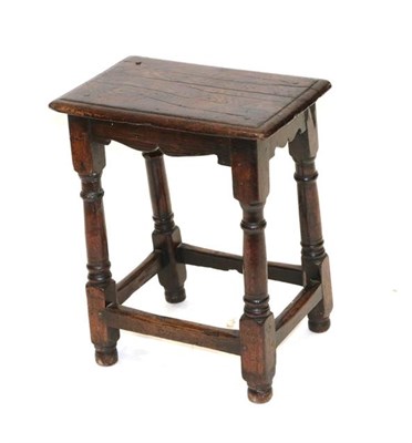 Lot 485 - A Victorian Oak Joint Stool, the moulded top with four pegs above an arched apron, on turned...