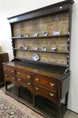 Lot 490 - A George III Oak Dresser and Rack, late 18th century, the upper section with moulded cornice...