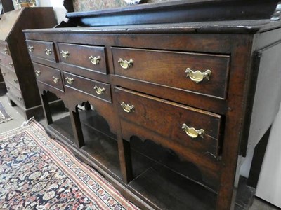 Lot 490 - A George III Oak Dresser and Rack, late 18th century, the upper section with moulded cornice...