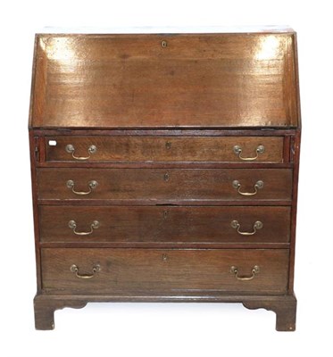 Lot 498 - A Mid 18th Century Oak Bureau, the fall front enclosing pigeon holes, small drawers and a...