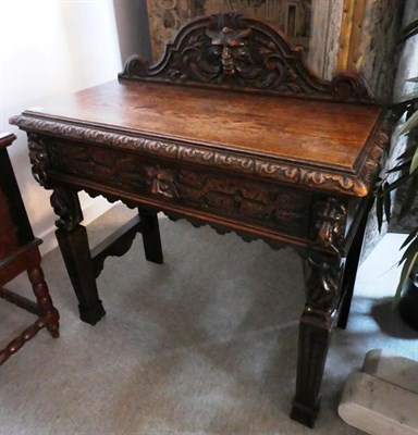 Lot 520 - A Victorian Carved Oak Hall Table, circa 1880, the scrolled pediment carved in relief above a...