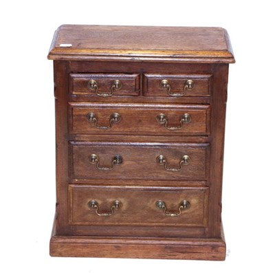 Lot 550 - A Victorian Stained Pine Miniature Chest, late 19th century, the moulded top above two short...
