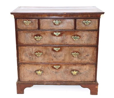 Lot 552 - A Walnut and Featherbanded Straight Front Chest, the later oak and mahogany crossbanded top...