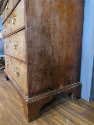 Lot 552 - A Walnut and Featherbanded Straight Front Chest, the later oak and mahogany crossbanded top...