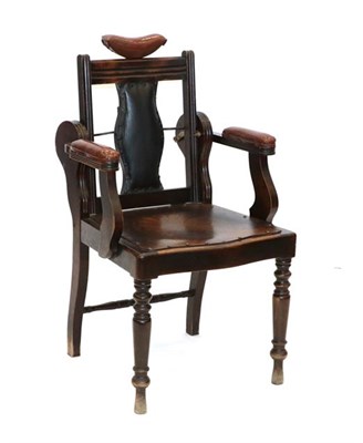 Lot 561 - An Early 20th Century Oak and Stained Beech Barber's Chair, with brown leatherette headrest and...