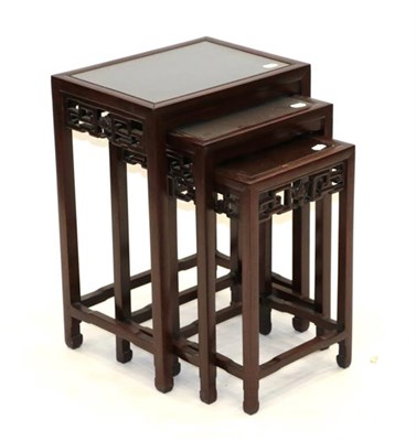 Lot 570 - A Set of Three Early 20th Century Chinese Hardwood Nesting Tables, of rectangular form, the moulded
