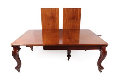 Lot 575 - A Victorian Carved Mahogany Wind-Out Dining Table, circa 1870, the three original leaves and a...