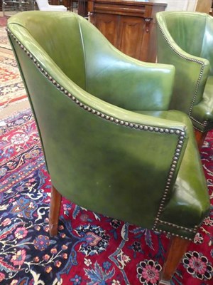 Lot 582 - A Set of Seven Club Armchairs, mid 20th century, covered in close-nailed green leather, the...