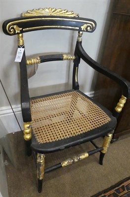 Lot 584 - A Pair of Regency-Style Ebonised and Parcel Gilt Armchairs, late 19th century, the carved top rails