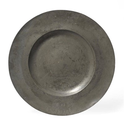 Lot 1302 - A Pewter Broad Rim Charger, 17th century, the rim with an armorial shield and a crest and...