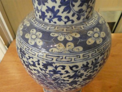 Lot 23 - A 19th century Chinese blue and white vase and cover, painted in underglaze blue with panels of...