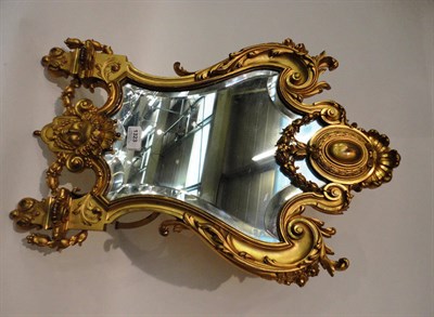 Lot 1323 - A French Ormolu Easel Back Vanity Mirror, circa 1900, of scroll edged shield shape enriched...