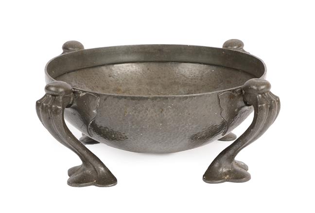 Lot 1030 - Oliver Baker for Liberty & Co: A Tudric Pewter Bowl, model 067, the hammered bowl on four...