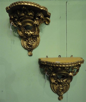 Lot 1336 - A Pair of Carved Wood and Gilt Gesso Wall Brackets, circa 1870, bowfront tops with tong and...