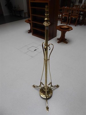 Lot 1043 - An Art Nouveau Brass Telescopic Standard Lamp, c.1910, on three whiplash supports, weighted...