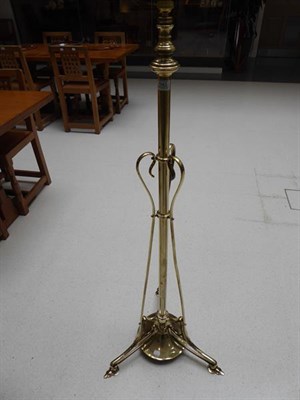 Lot 1043 - An Art Nouveau Brass Telescopic Standard Lamp, c.1910, on three whiplash supports, weighted...