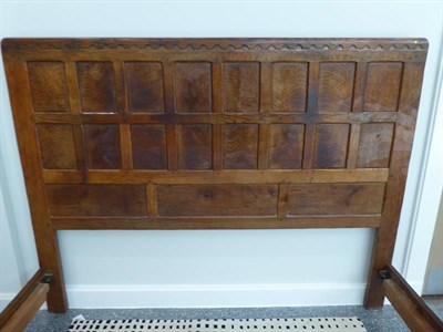 Lot 1054 - Robert Mouseman Thompson (1876-1955): An English Oak 5ft Panelled Bedstead, penny moulded top, with