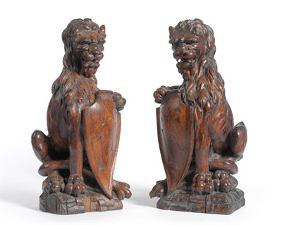 Lot 1339 - A Pair of Carved Oak Lion Finials, 19th century, in medieval style, each seated on its haunches...