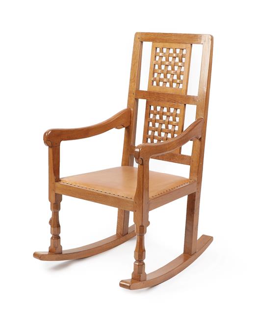 Lot 1064 - Workshop of Robert Mouseman Thompson (Kilburn): An English Oak Rocking Chair, with two lattice...