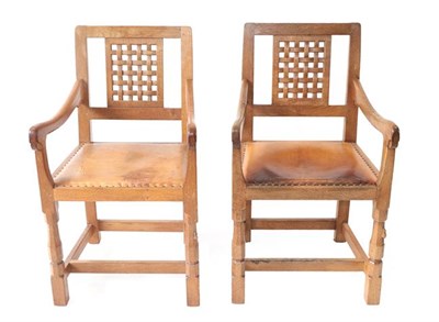 Lot 1096 - Workshop of Robert Mouseman Thompson (Kilburn): Two English Oak Lattice Back Arm Chairs,...