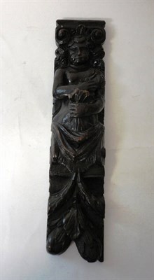 Lot 1344 - A Carved Oak Figural Bracket, 17th century, with Doric capital over a naive caryatid figure holding