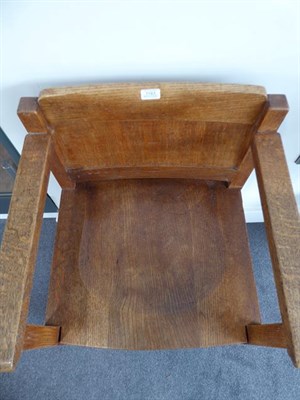 Lot 1183 - An Arts & Crafts Oak Armchair, solid shaped seat and back, on four square section legs,...