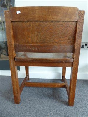 Lot 1183 - An Arts & Crafts Oak Armchair, solid shaped seat and back, on four square section legs,...