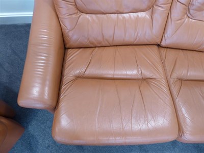 Lot 1187 - A Tetrad Brown Leather Sofa and Armchair, on brown castors, both labelled tetrad ENGLAND MAKERS...