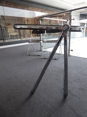 Lot 1192 - A Platone Folding Table, designed by Giancarlo Piretti, brown moulded perspex, on chrome steel...