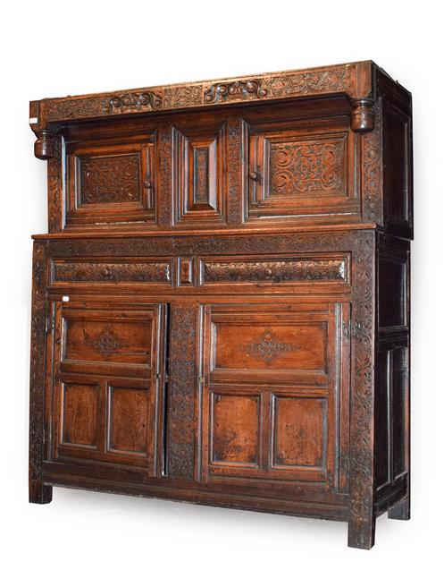 Lot 468 - .A 17th Century Joined Oak Press Cupboard, carved and dated 1694, initialled WGC, the frieze carved