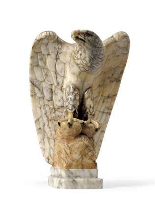 Lot 1365 - A Carved Veined Marble Model of an Eagle, 20th century, with wings partially spread on a rocky base