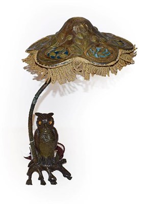 Lot 50 - An Austrian bronze owl table lamp and shade, the owl's glass eyes flicker when the switch is turned