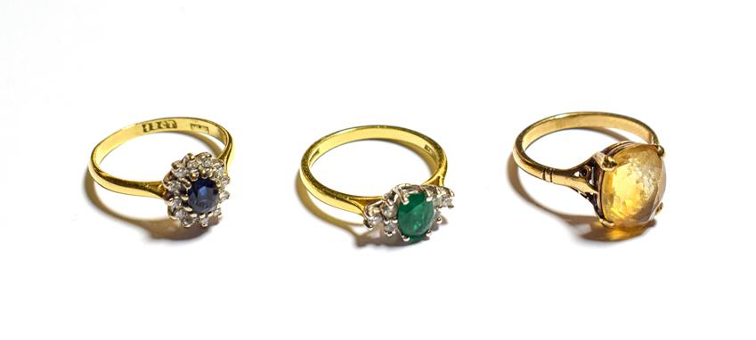 Lot 64 - An 18 carat gold emerald and diamond ring, finger size M, a sapphire and diamond cluster ring,...