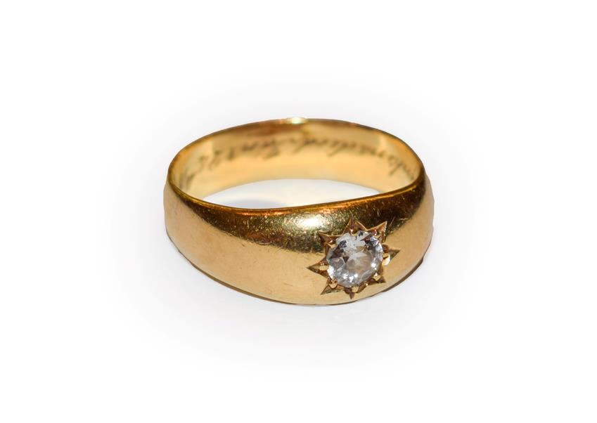 Lot 64 - A diamond solitaire ring, the old cut diamond in a yellow star setting on a plain polished...