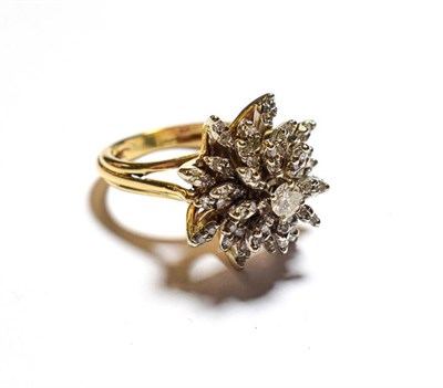 Lot 76 - A diamond cluster ring, the central raised round brilliant cut diamond within a radiating border of