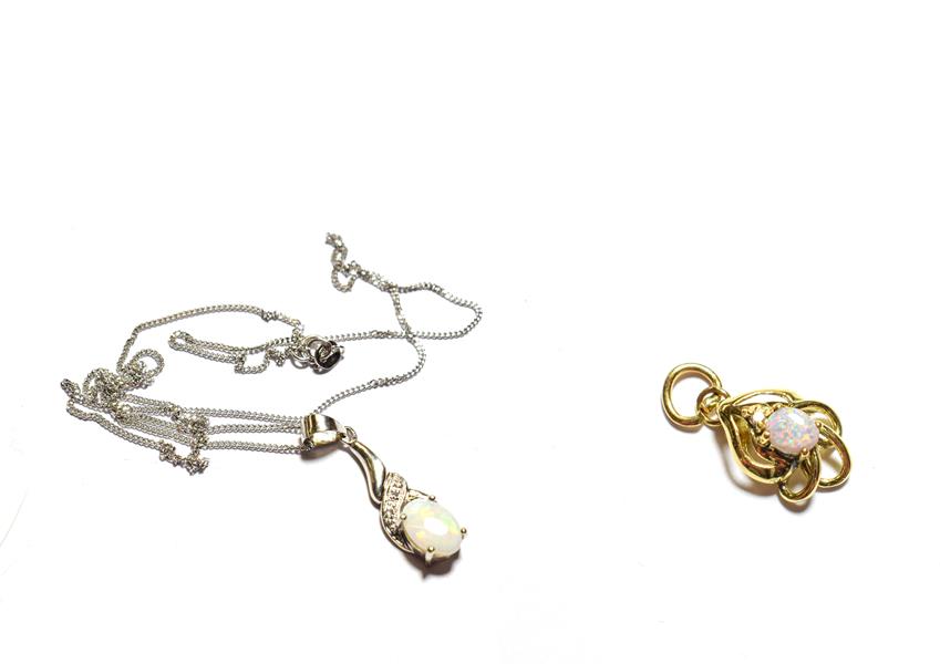 Lot 78 - A 9 carat white gold opal pendant on a trace link chain, pendant length 2.7cm, chain length 45.5cm
