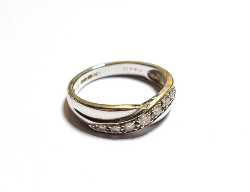 Lot 94 - A 9 carat white gold diamond twist ring, finger size N