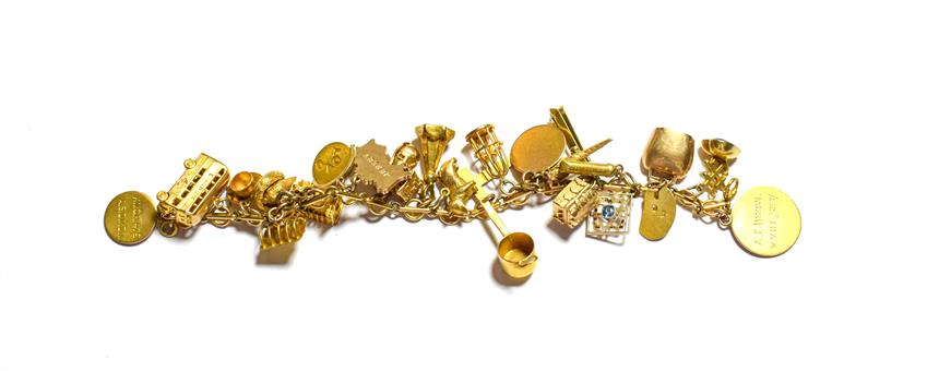 Lot 97 - A charm bracelet, stamped '9C', hung with various charms including a bus, a toast rack, a...