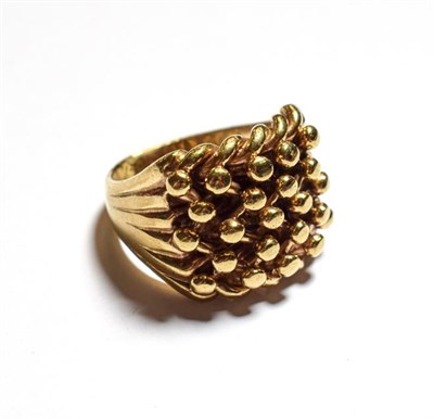Lot 105 - A 9 carat gold beaded motif ring, finger size Z1