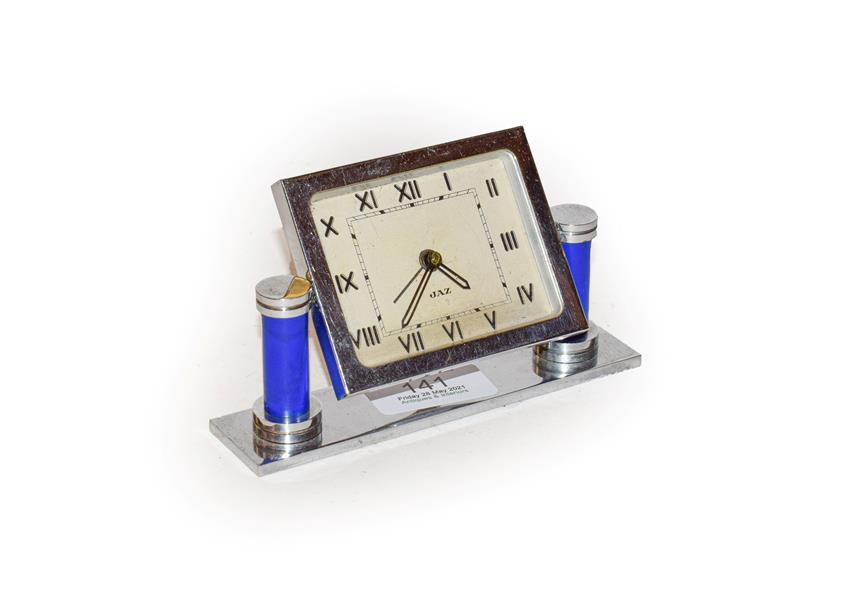 Lot 141 - An Art Deco chrome plated bedside alarm timepiece, dial signed 'Jaz', raised upon blue columns, 8cm