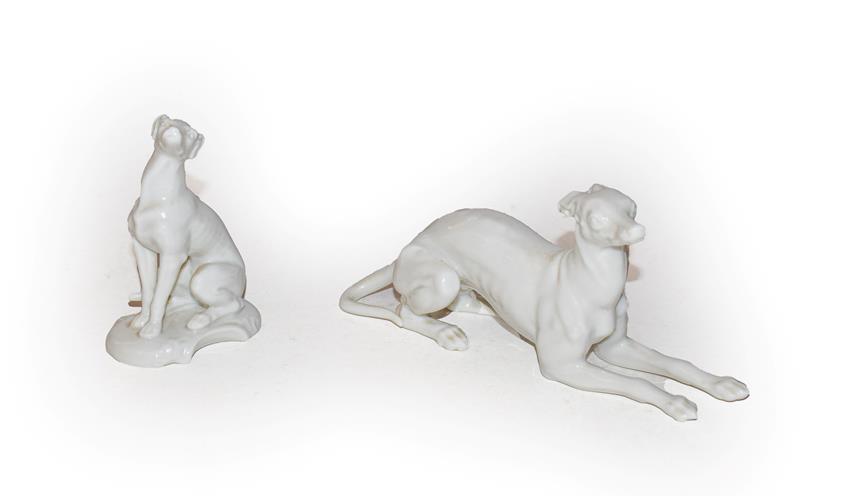 Lot 145 - Two Nymphenburg blanc de chine models of greyhounds, one in expectant pose and the other seated...